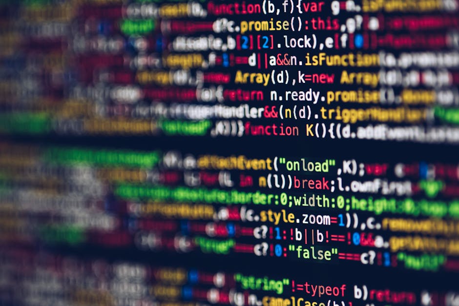 Close-up image of a computer screen displaying colorful lines of programming code, including functions, variables, and syntax highlighting in shades of red, green, blue, yellow, and white. The code ap